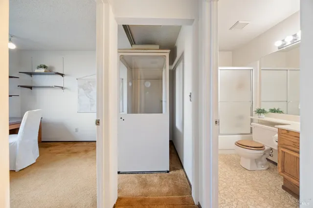 a bathroom with a toilet and a shower