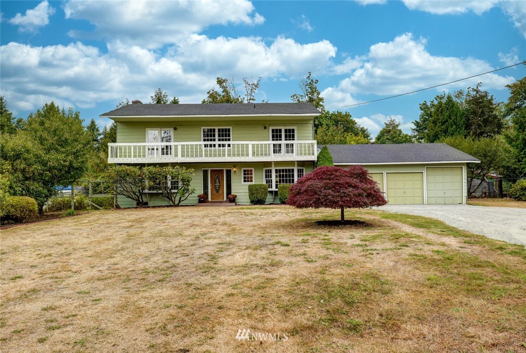 17002 Southeast 128th Street Renton, WA 98059 - Photo 2 of 30 a front view of a house with a yard and garage
