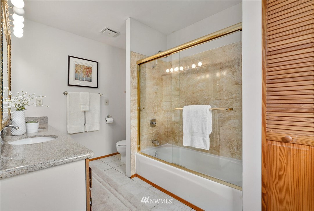 17002 Southeast 128th Street Renton, WA 98059 - Photo 21 of 30 a bathroom with a granite countertop sink mirror and bathtub
