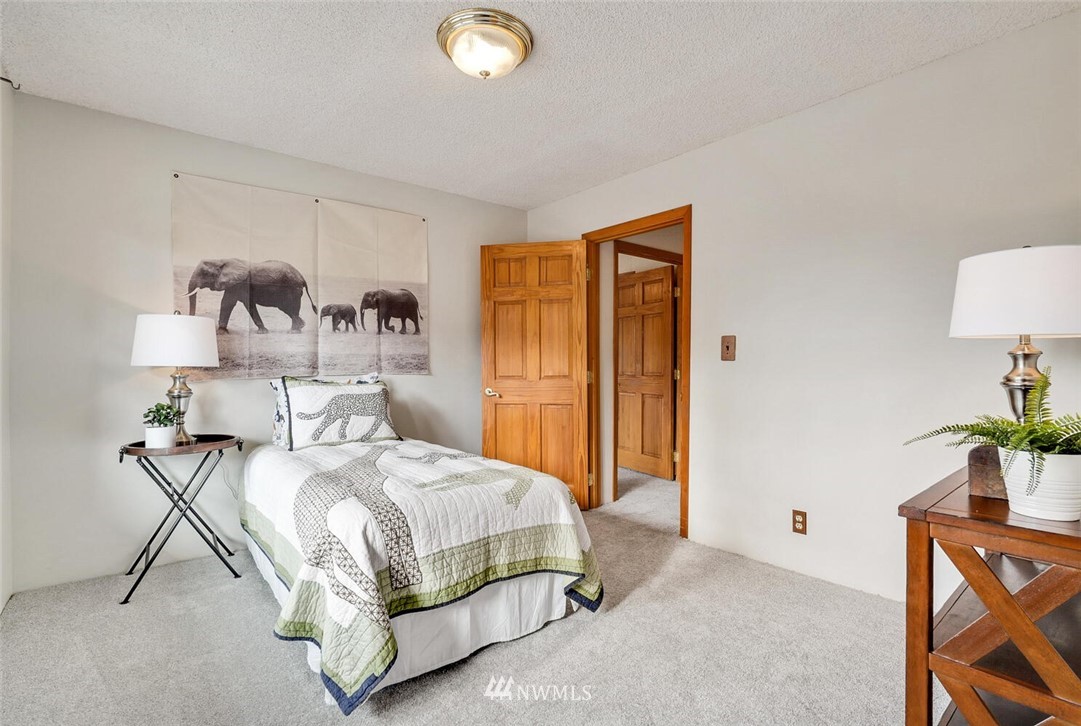 17002 Southeast 128th Street Renton, WA 98059 - Photo 22 of 30 a bedroom with a bed and a potted plant on th dresser