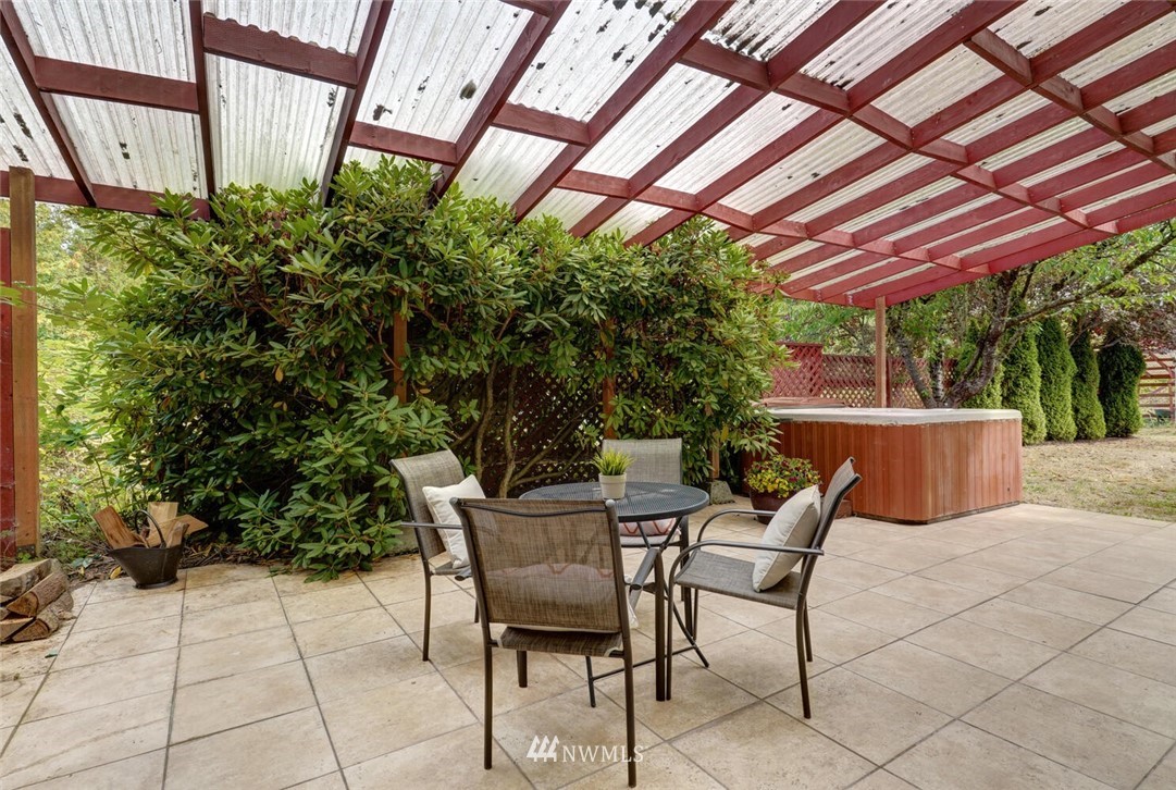 17002 Southeast 128th Street Renton, WA 98059 - Photo 25 of 30 a view of a patio with table and chairs and potted plants