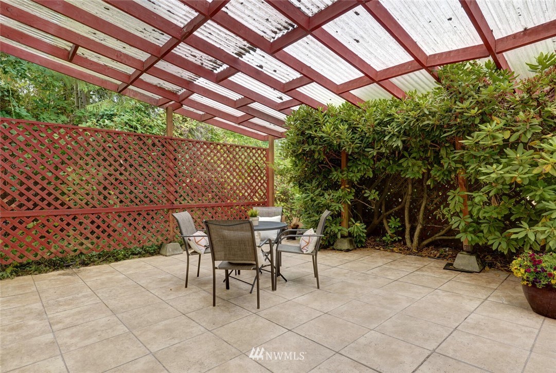 17002 Southeast 128th Street Renton, WA 98059 - Photo 26 of 30 a patio with a table and chairs and potted plants