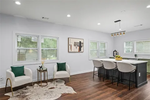a view of a dining room with furniture window and wooden floor