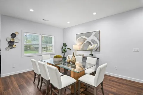 a dining room with furniture a window and wooden floor