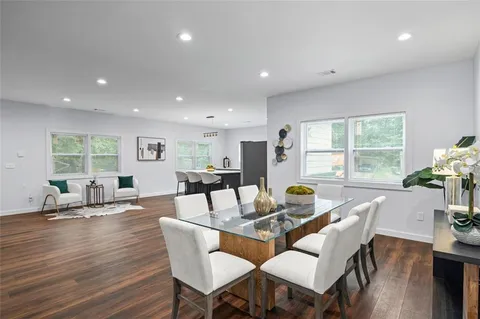 a dining room with furniture and wooden floor