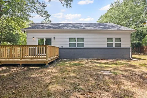 a bedroom with a bed a window and a chandelier