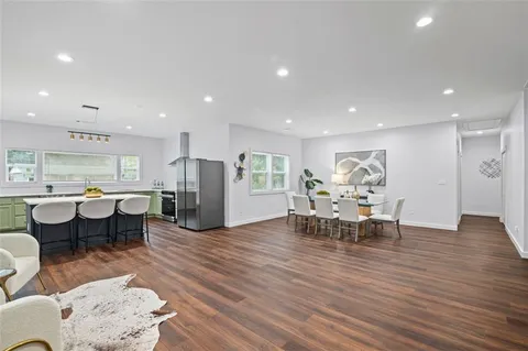 a view of a dining room with furniture and wooden floor