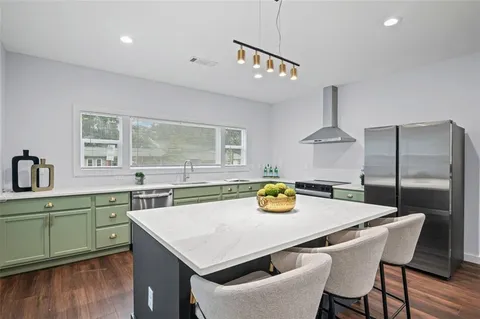 a kitchen with a table a sink and cabinets