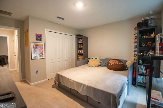 a bedroom with a bed and closet