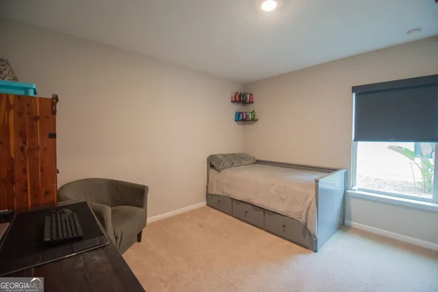 a bedroom with a bed and window