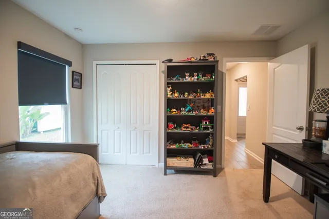 a bedroom with furniture and a window