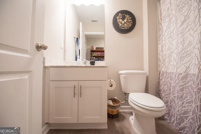 a bathroom with a toilet and a sink