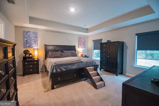 a bedroom with a bed and a tv on the dresser