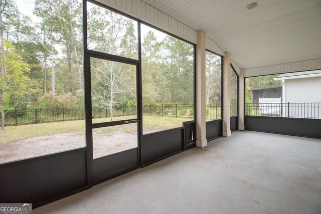 a view of an empty room with windows