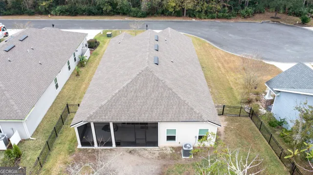 an aerial view of a house with a swimming pool