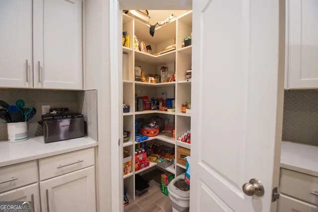 a kitchen with a refrigerator and cabinets
