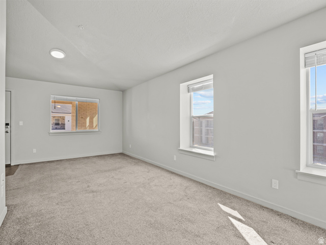 64 West 600 South, Unit C301 Springville, UT 84663 - Photo 8 of 40 Carpeted empty room featuring plenty of natural light and a textured ceiling