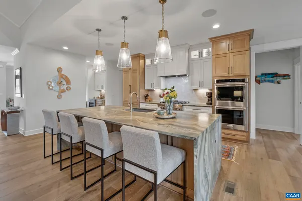 a kitchen with a table chairs refrigerator and microwave