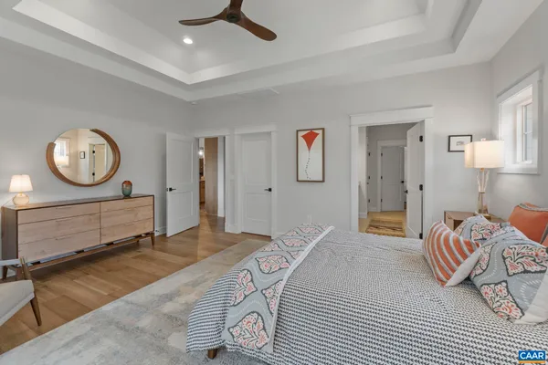a bedroom with a bed a clock and a table