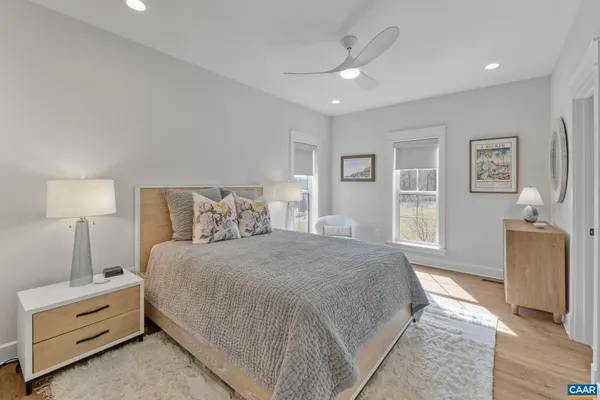 a spacious bedroom with a bed and a mirror