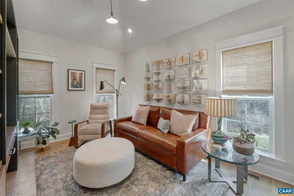 a living room with furniture and a wooden floor