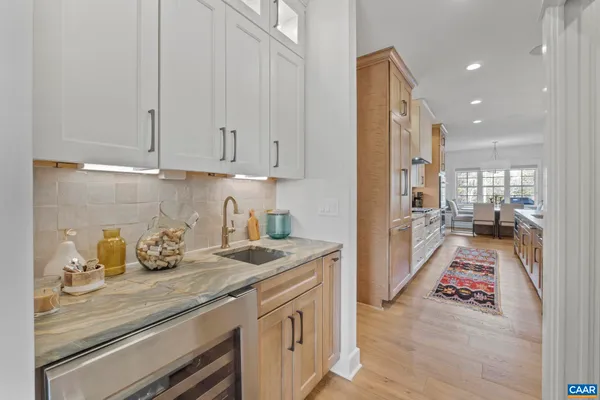 a kitchen with granite countertop a sink and dishwasher stove top oven