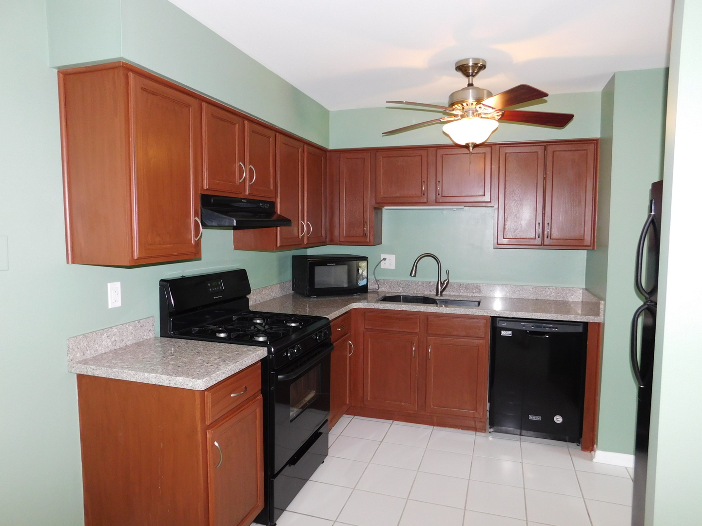 19398 Wolf Road, Unit 8 Mokena, IL 60448 - Photo 5 of 9 a kitchen with stainless steel appliances granite countertop a sink stove and refrigerator