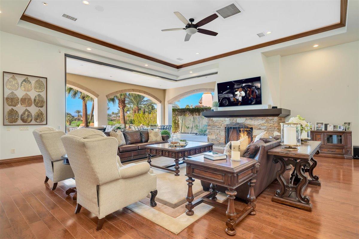 58445 Carmona La Quinta, CA 92253 - Photo 11 of 70 a living room with fireplace furniture and a flat screen tv