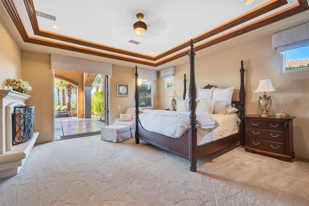 58445 Carmona La Quinta, CA 92253 - Photo 19 of 70 a bedroom with a bed and a chandelier