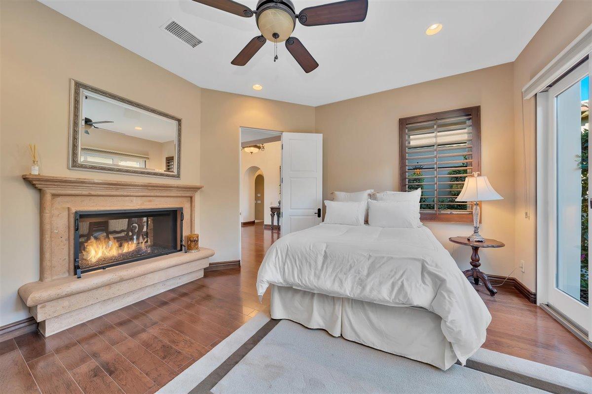 58445 Carmona La Quinta, CA 92253 - Photo 24 of 70 a spacious bedroom with a bed and a fireplace
