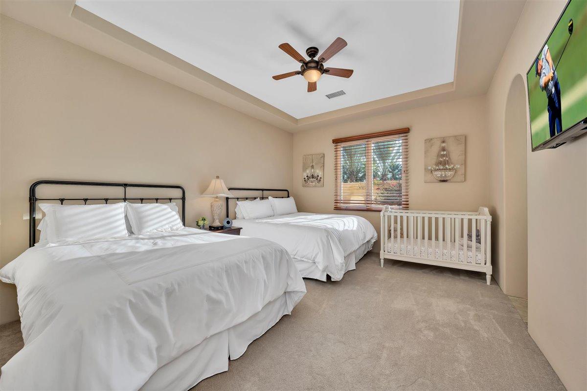 58445 Carmona La Quinta, CA 92253 - Photo 25 of 70 a bedroom with two beds and a chandelier