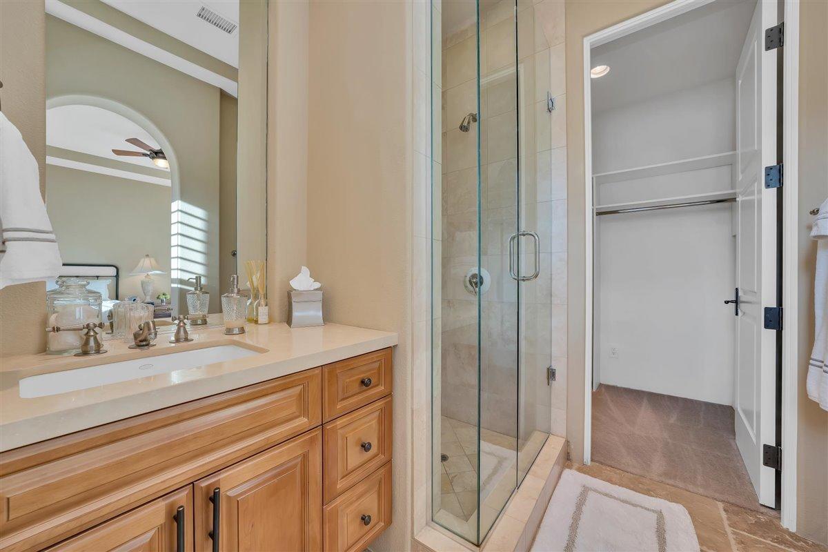 58445 Carmona La Quinta, CA 92253 - Photo 26 of 70 a bathroom with a sink a mirror and a shower