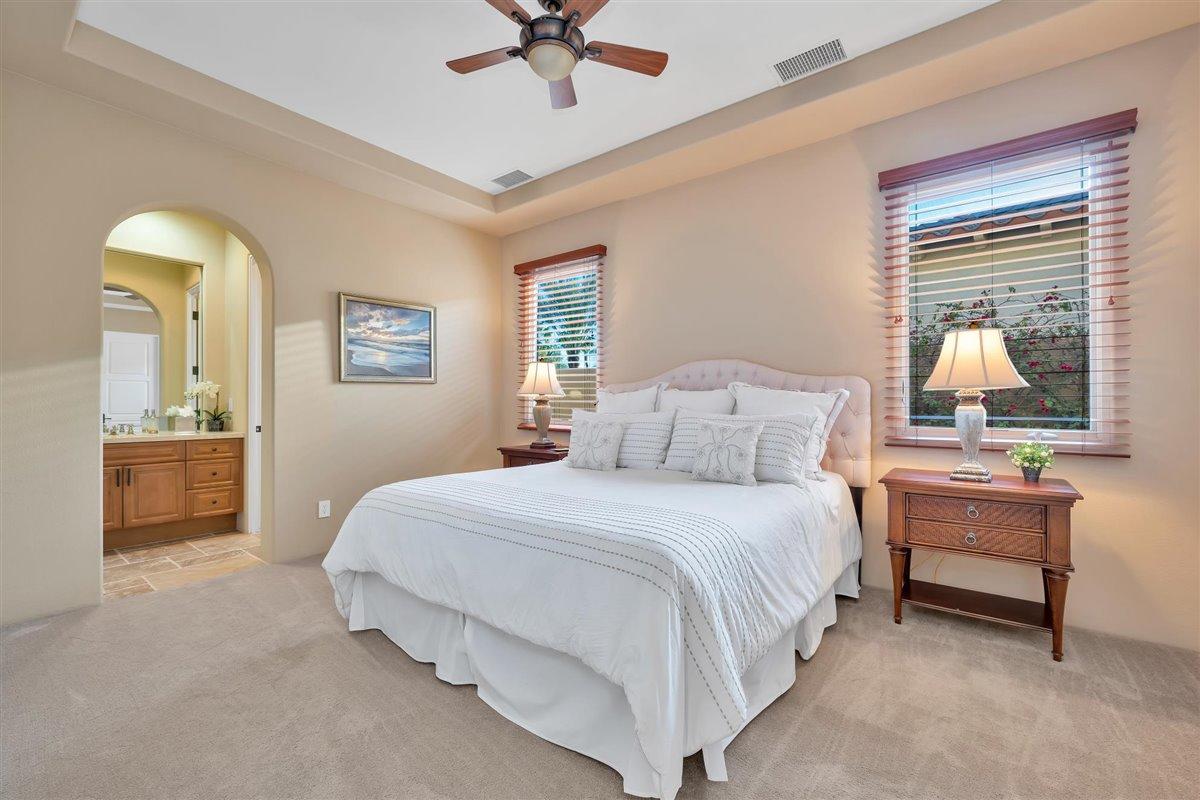 58445 Carmona La Quinta, CA 92253 - Photo 27 of 70 a bedroom with a bed and a chandelier