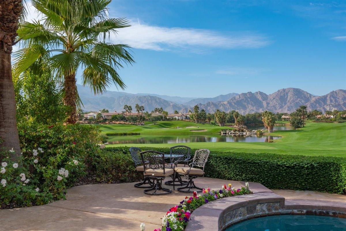 58445 Carmona La Quinta, CA 92253 - Photo 3 of 70 a view of a garden with a table under an umbrella