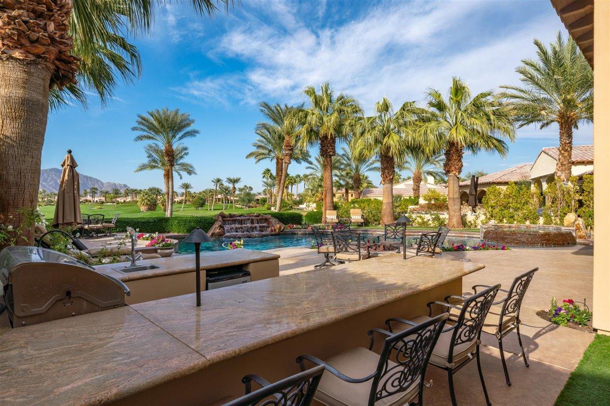 58445 Carmona La Quinta, CA 92253 - Photo 37 of 70 a view of a swimming pool with a table and chairs