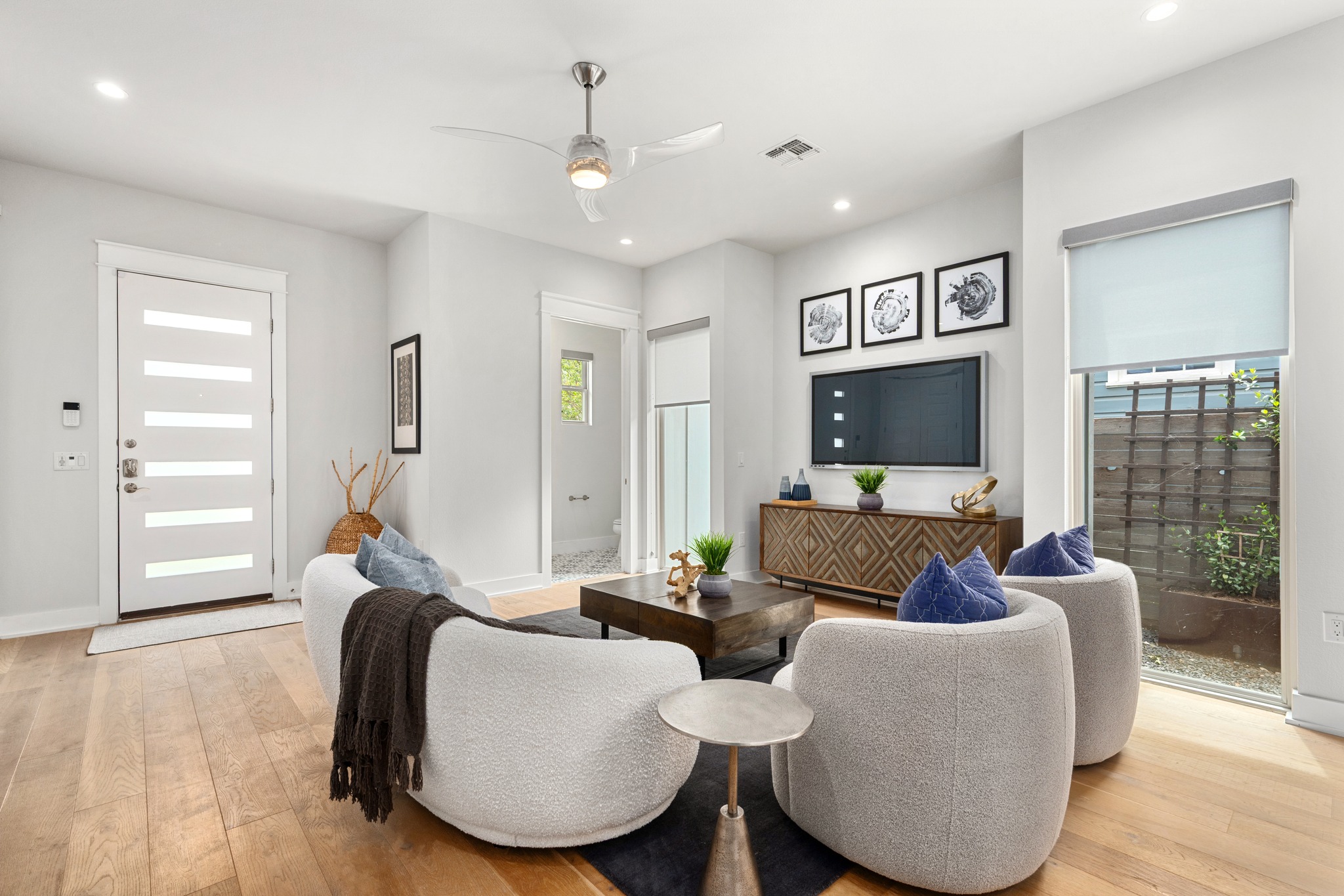 1409 Alegria Road, Unit A Austin, TX 78757 - Photo 5 of 24 Hardwood floors and a sleek ceiling fan define this inviting living space.