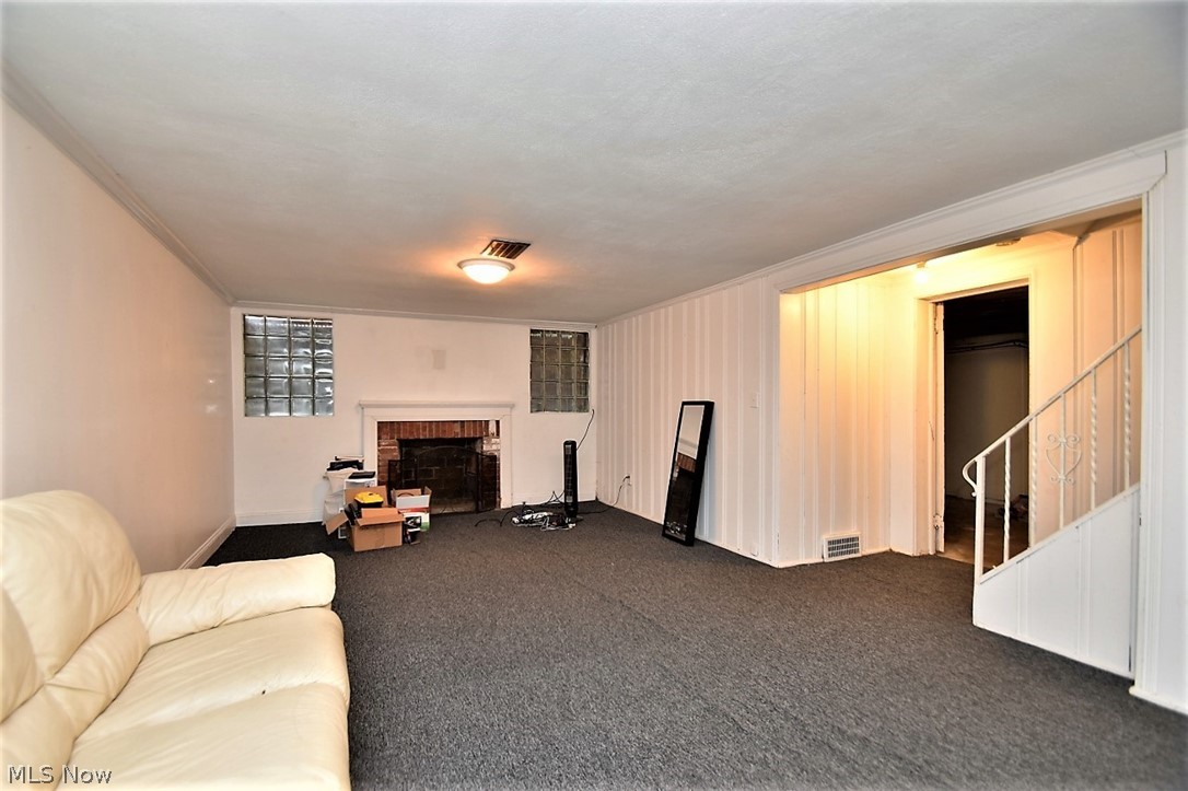 2487 Fenwick Road Cleveland, OH 44118 - Photo 15 of 16 Carpeted lower level with non-functioning fireplace