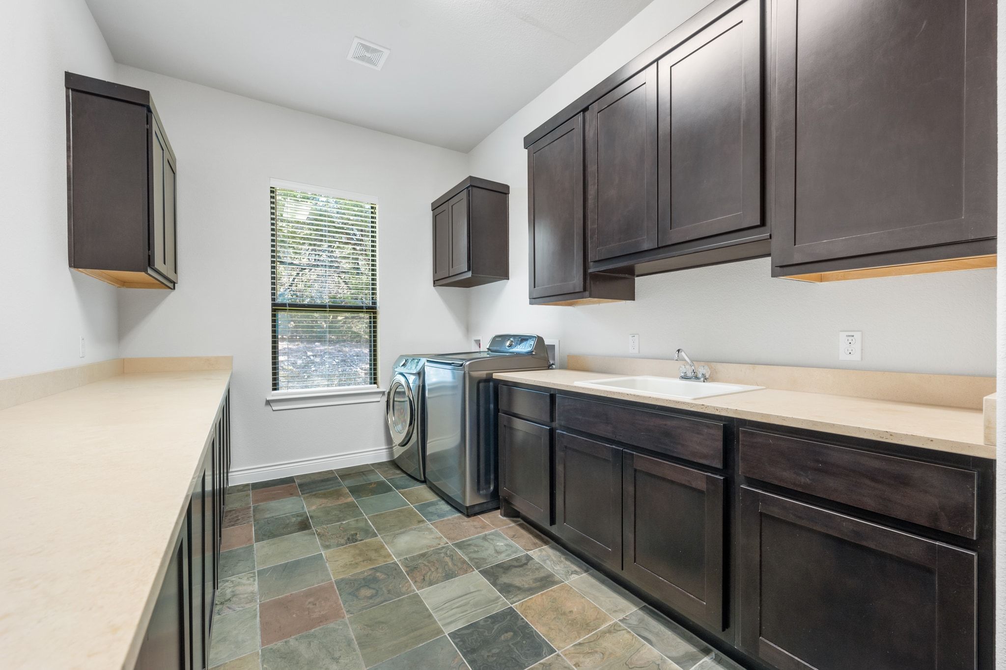 20607 Thurman Bend Road Spicewood, TX 78669 - Photo 28 of 39 a kitchen with stainless steel appliances a sink stove and cabinets