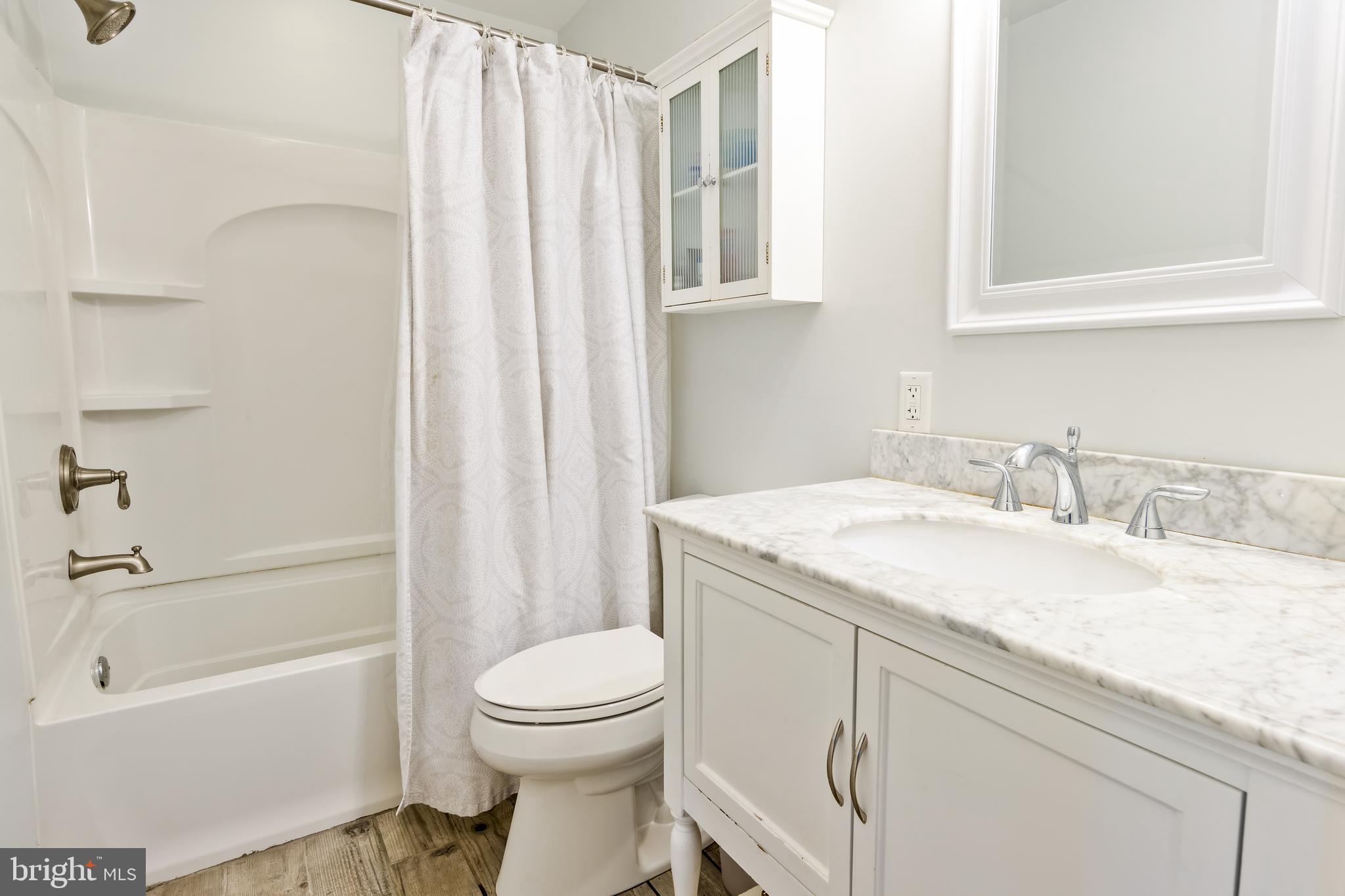 668 Davis Lane Wayne, PA 19087 - Photo 18 of 21 Renovated Hall Bath with marble-countered vanity
