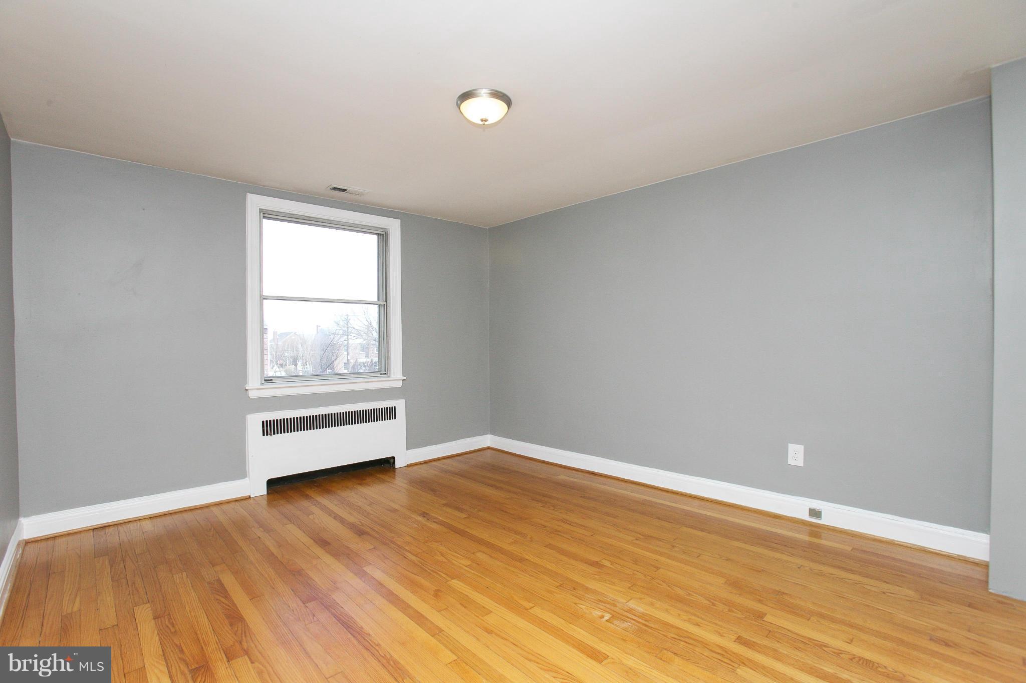 3802 Yolando Road Baltimore, MD 21218 - Photo 13 of 27 an empty room with wooden floor and windows