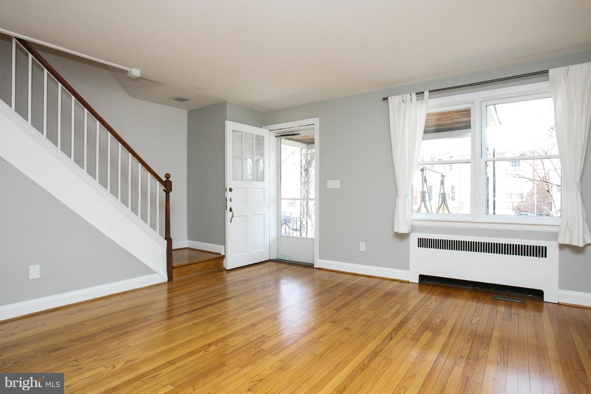 3802 Yolando Road Baltimore, MD 21218 - Photo 3 of 27 a view of an empty room with wooden floor and a window