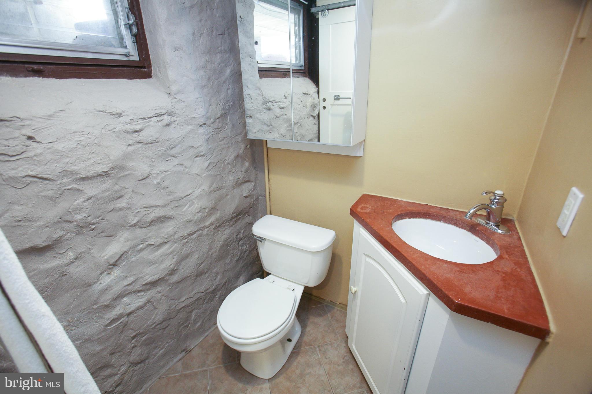 3802 Yolando Road Baltimore, MD 21218 - Photo 24 of 27 a bathroom with a toilet sink and mirror