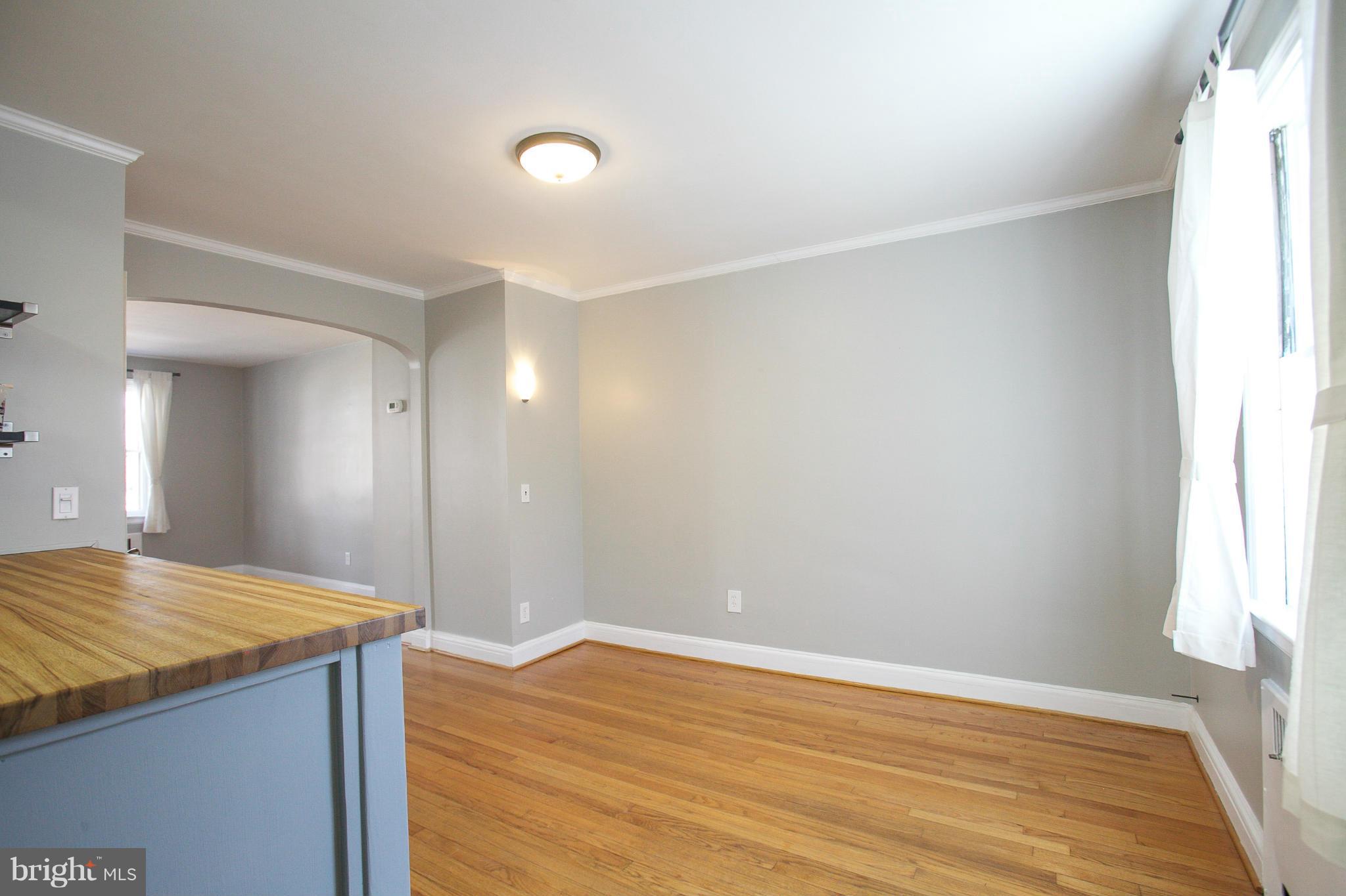 3802 Yolando Road Baltimore, MD 21218 - Photo 6 of 27 a view of kitchen and hallway with wooden floor