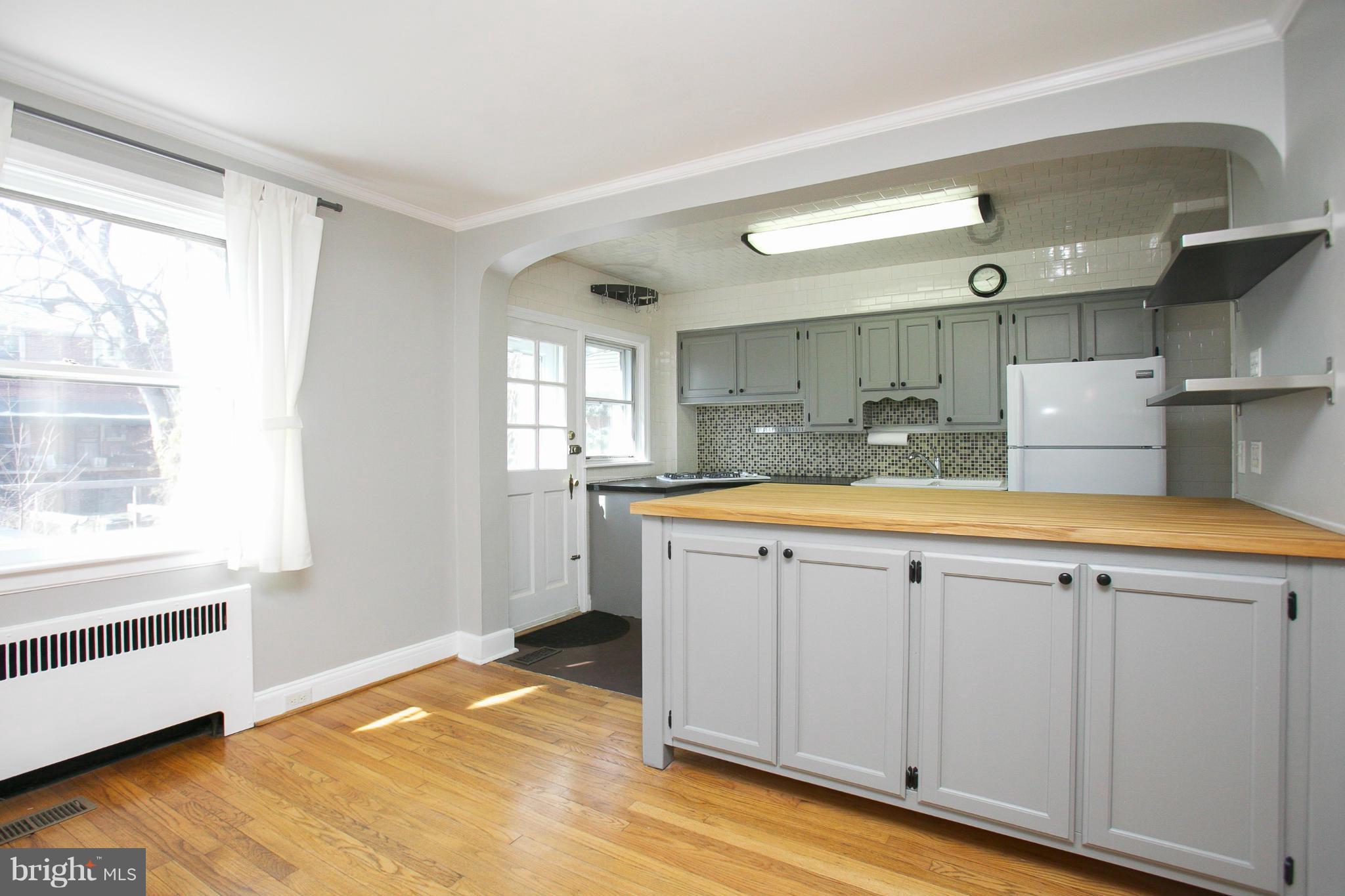 3802 Yolando Road Baltimore, MD 21218 - Photo 7 of 27 a view of a kitchen with wooden floor and a sink