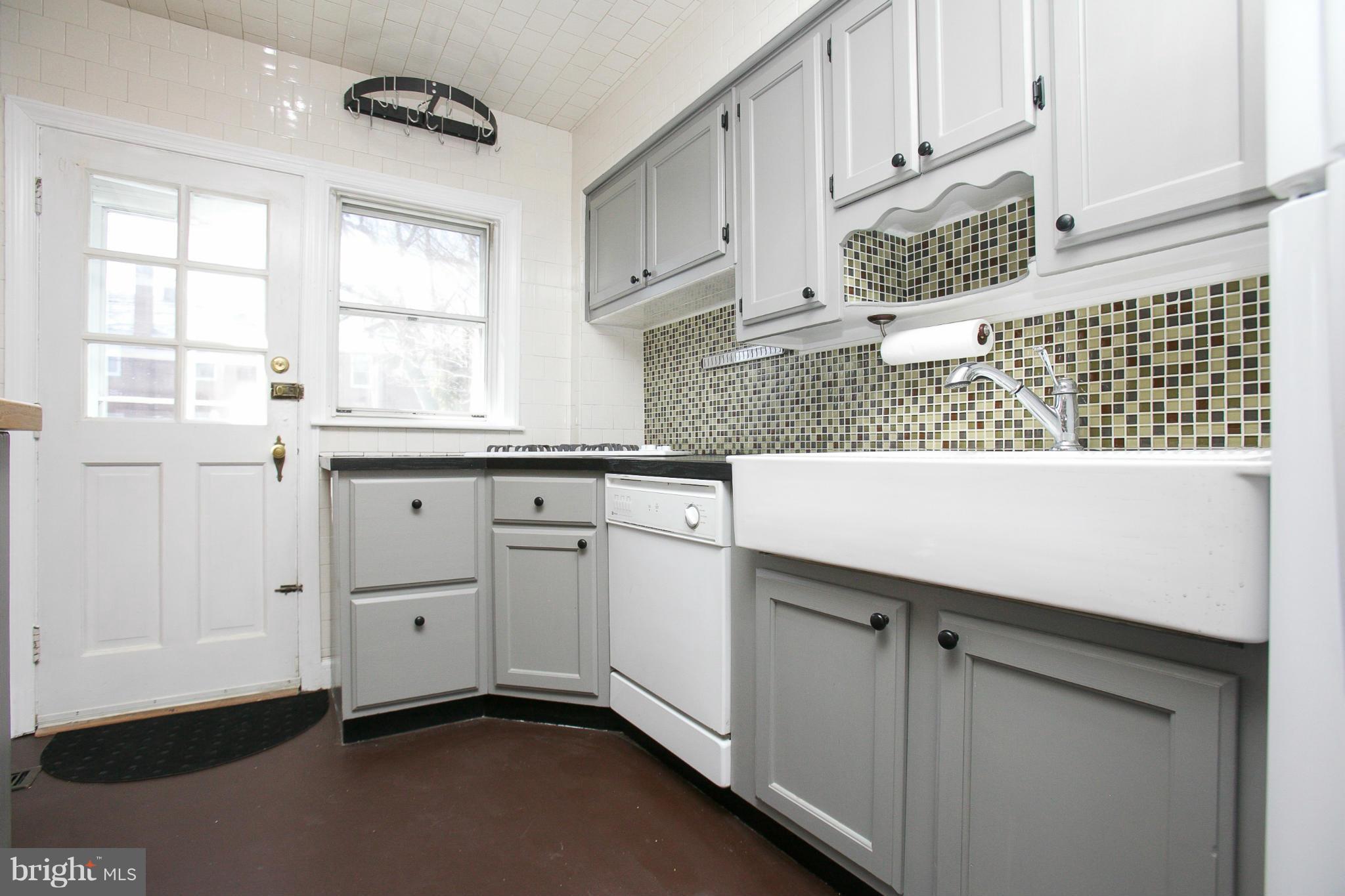 3802 Yolando Road Baltimore, MD 21218 - Photo 10 of 27 a kitchen with white cabinets and window