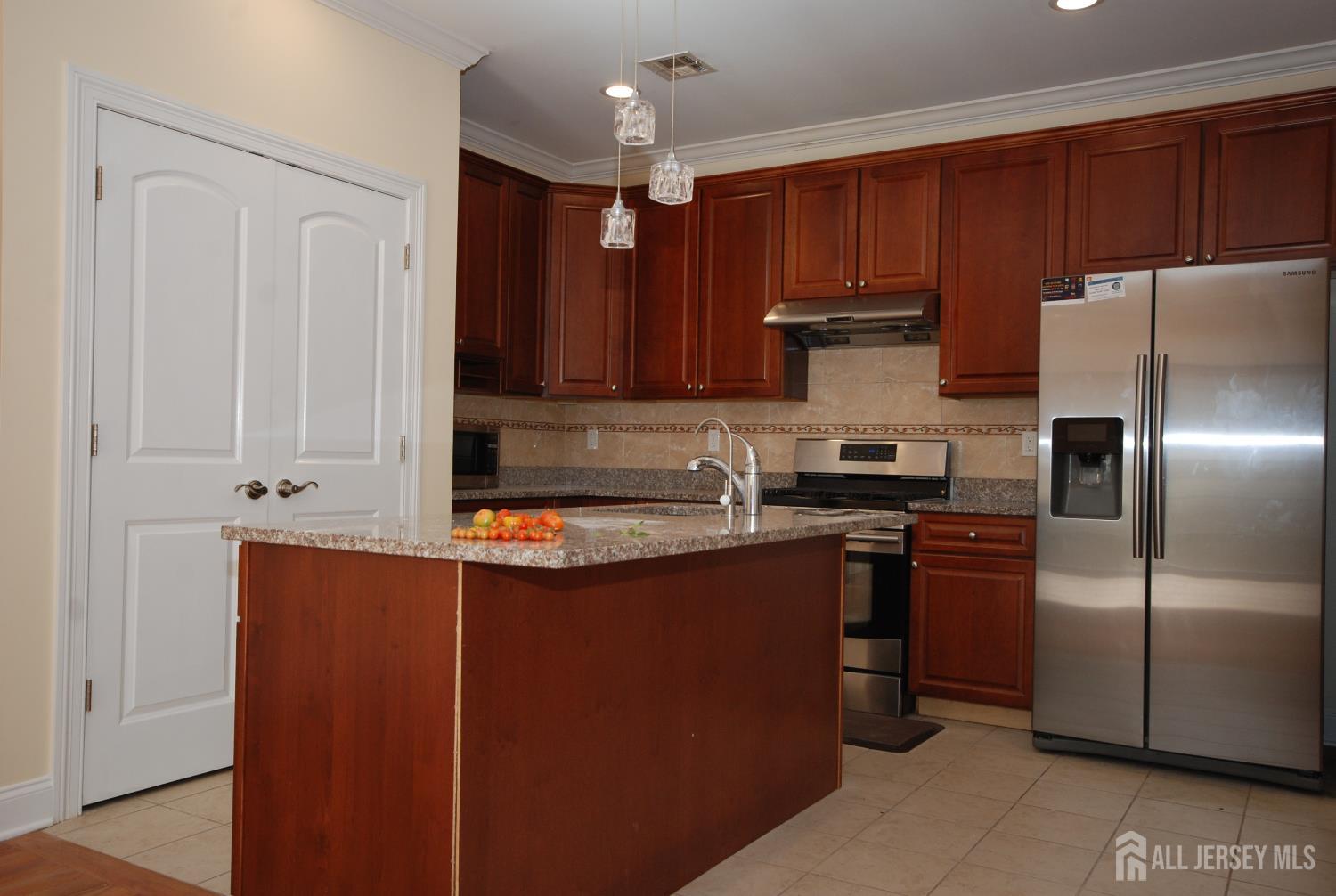 32 Cinder Road, Unit 3 Edison, NJ 08820 - Photo 12 of 34 a kitchen with stainless steel appliances granite countertop a refrigerator sink and cabinets