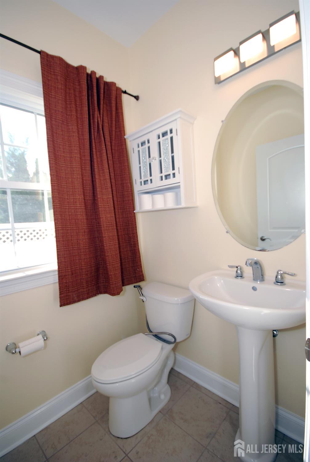 32 Cinder Road, Unit 3 Edison, NJ 08820 - Photo 14 of 34 a bathroom with a toilet a sink and a mirror
