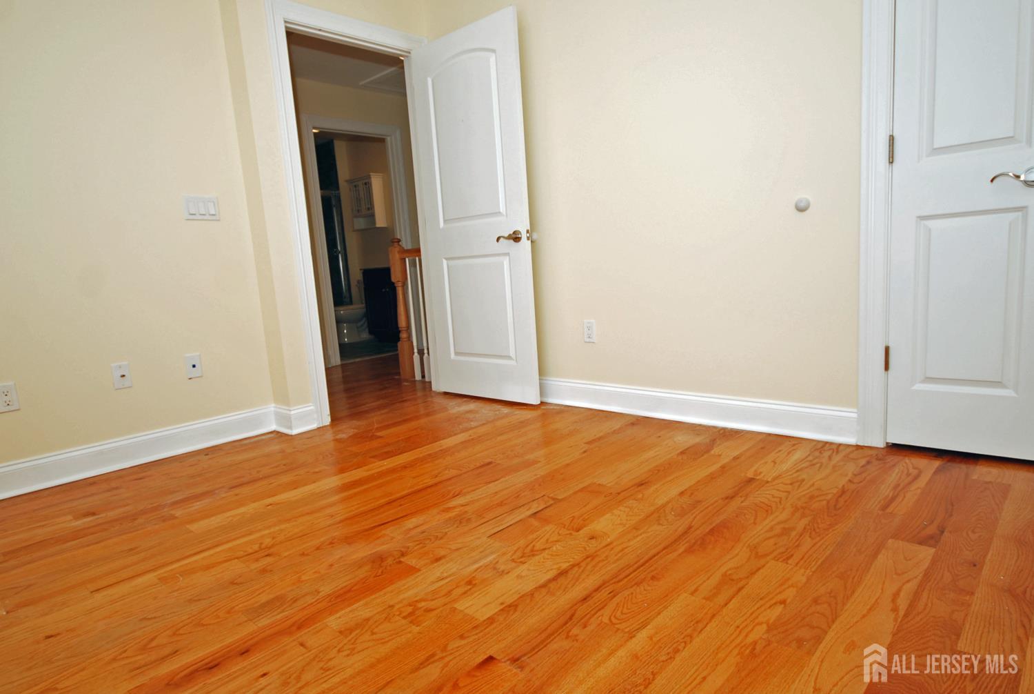 32 Cinder Road, Unit 3 Edison, NJ 08820 - Photo 19 of 34 an empty room with wooden floor and closet