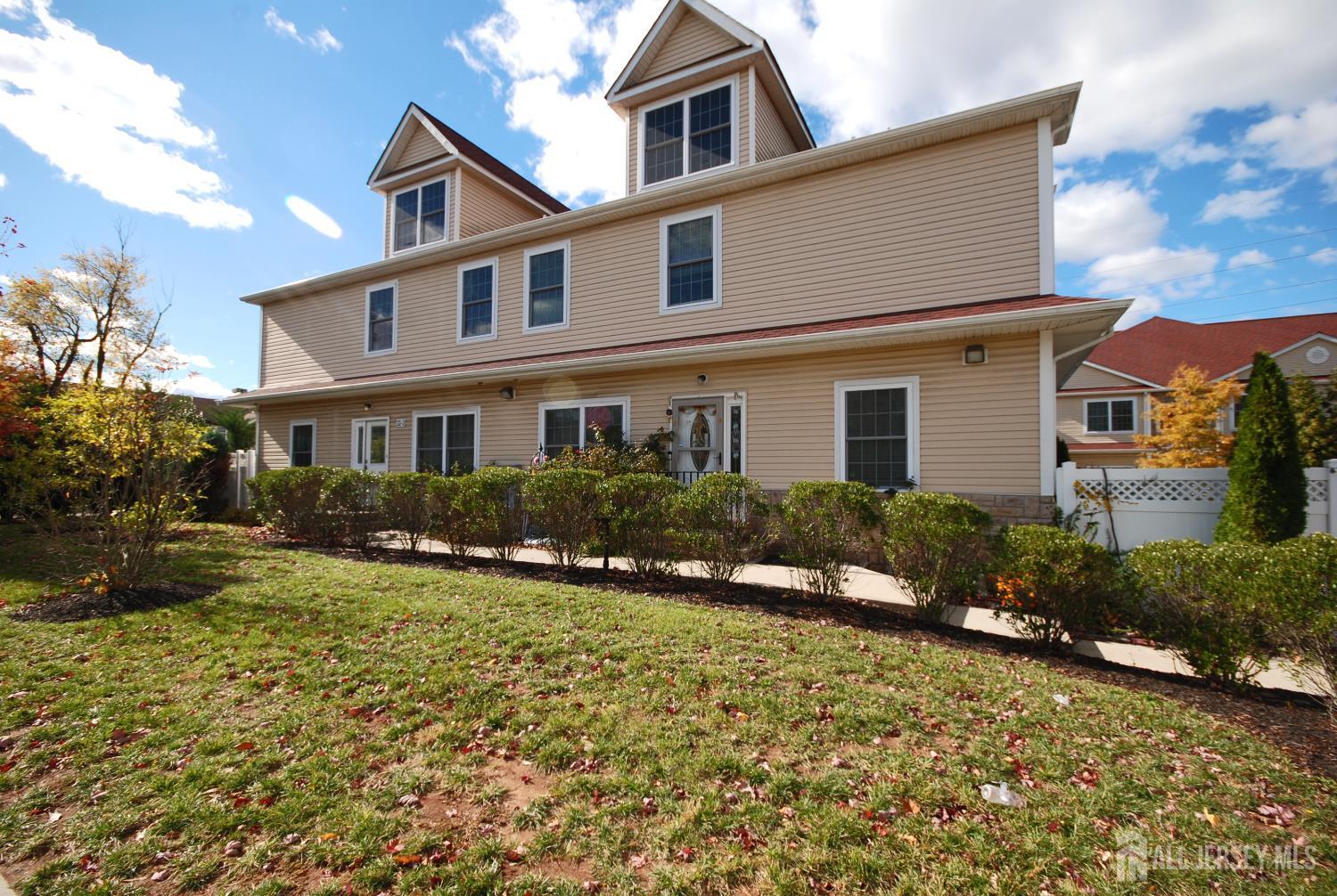 32 Cinder Road, Unit 3 Edison, NJ 08820 - Photo 2 of 34 a front view of a house with a yard