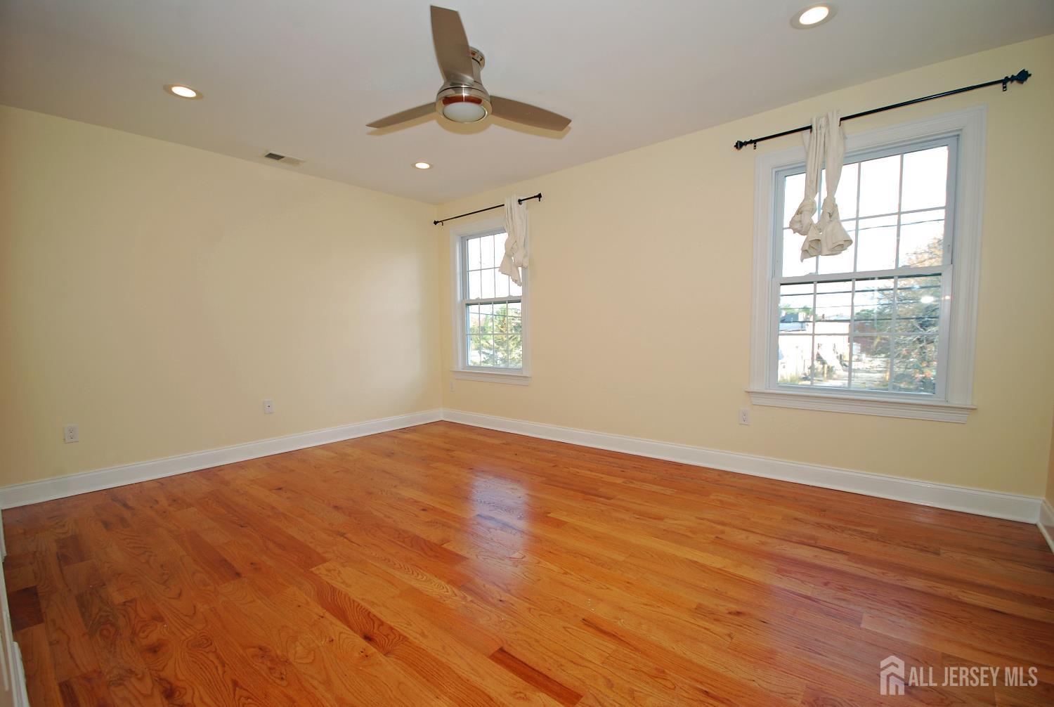 32 Cinder Road, Unit 3 Edison, NJ 08820 - Photo 25 of 34 a view of an empty room with wooden floor and a window